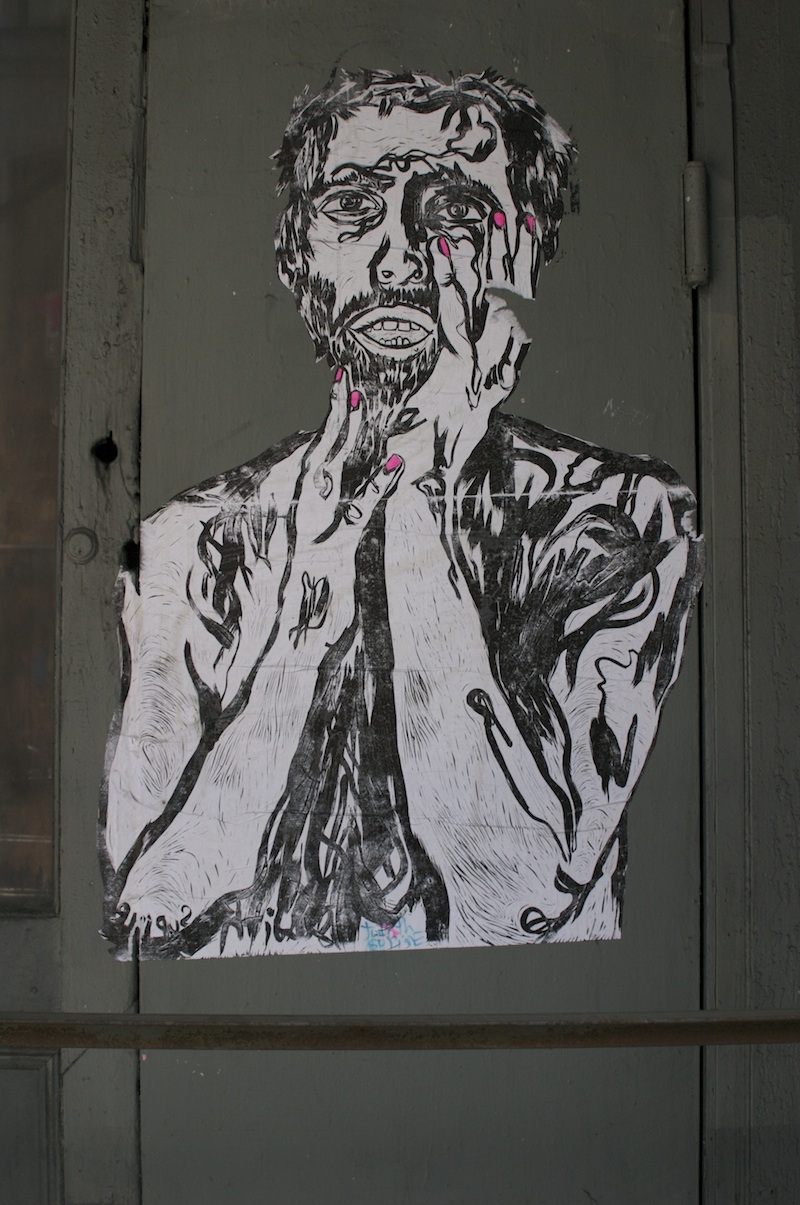 A wheatpaste of a block print by Judith Supine. Photo by Garrison Gunter.