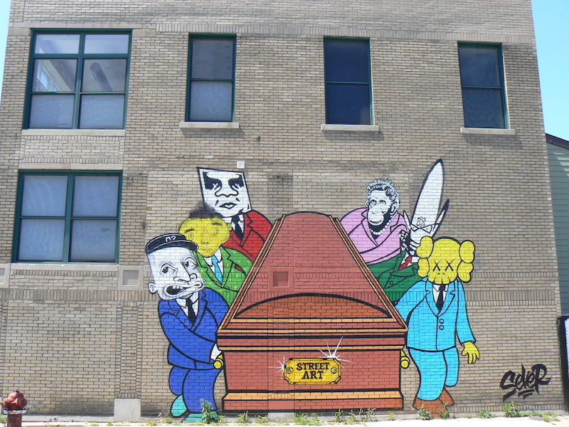 Sever's Death of Street Art piece in Hamtramck, Michigan references Shepard Fairey, Os Gêmeos, Barry McGee, Banksy, Futura and KAWS. Photo by Brian Knowles.