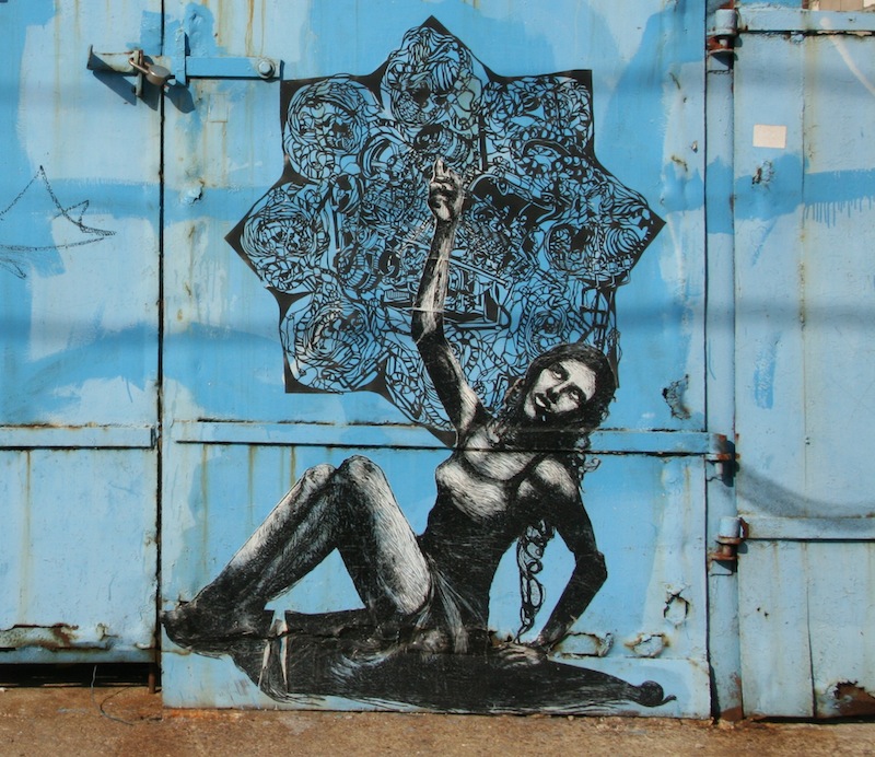 A wheatpaste made up of a block print and a papercut by Robyn Hasty aka Imminent Disaster. Photo by carnagenyc.